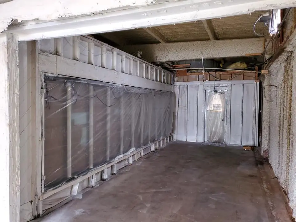 Basement framing stripped back to clean studs during remediation