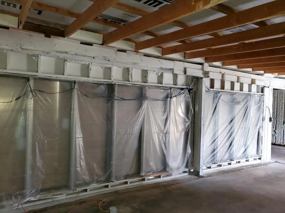 Basement framing stripped back to clean studs during remediation