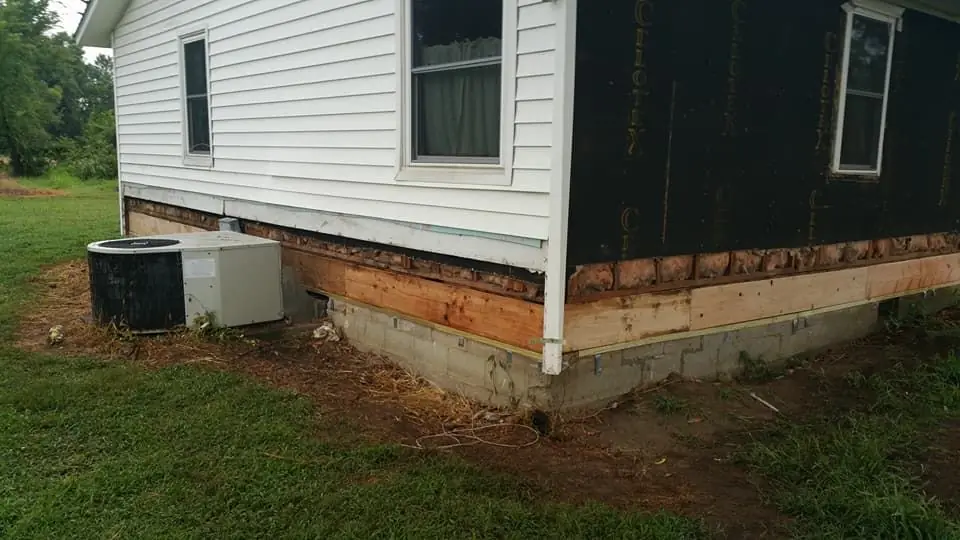 House exterior with the skirting opened up for crawlspace work