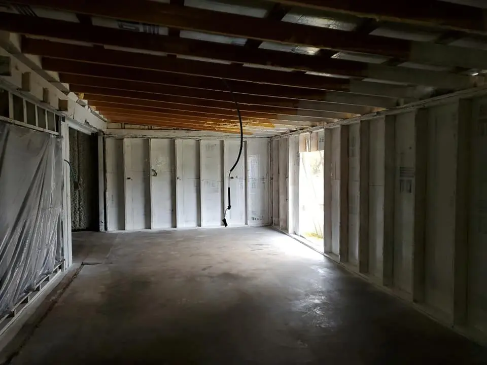Basement framing stripped back to clean studs during remediation
