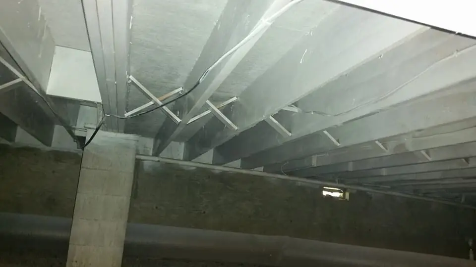 Crawlspace floor joists and subfloor during a job